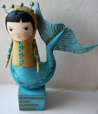 mermaid on blue block.