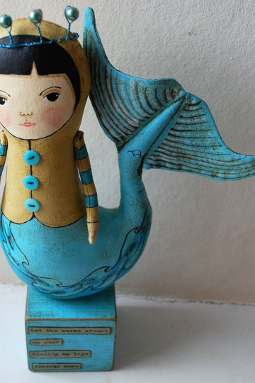 mermaid on blue block.